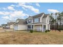 Inviting two-story home with a covered front porch and a well-maintained lawn at 104 Coats Ridge Dr, Benson, NC 27504