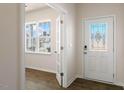 Bright foyer features elegant door with glass insert and sidelight window, and a storm door at 106 Paper Birch Way, Fuquay Varina, NC 27526