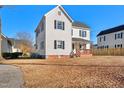 White two-story home with black shutters and a small front porch at 107 N 12Th St, Erwin, NC 28339