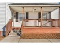 Close-up of the front porch with brick base and wood railings at 107 N 12Th St, Erwin, NC 28339