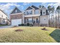 Attractive two-story home with a covered front porch and a combination of siding and stone accents at 113 Palladium Ct, Elon, NC 27244