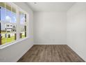 Bright living room with a large window offering pleasant neighborhood views at 113 Paper Birch Way, Fuquay Varina, NC 27526