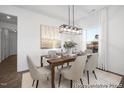 Elegant dining room with modern lighting, neutral décor, and a view to the front yard at 113 Seneca Dr # 759, Louisburg, NC 27549