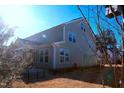 Spacious backyard featuring a well-maintained lawn and a full-house width screened in porch at 1136 Knotty Oaks Dr, Apex, NC 27523