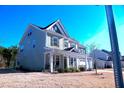 Two-story home with a charming front porch and two car garage at 1136 Knotty Oaks Dr, Apex, NC 27523