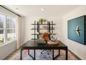 Bright home office with large window, black desk, stylish shelving, and contemporary decor at 120 Paper Birch Way, Fuquay Varina, NC 27526