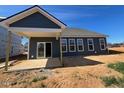 Stylish home exterior featuring a covered patio and ample natural light at 121 Willow Cameron Way, Angier, NC 27501