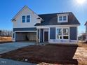 Charming two-story home with a two-car garage and a well-lit exterior at 121 Willow Cameron Way, Angier, NC 27501