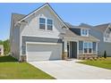 Attractive two-story home with a 2-car garage, stone accents, and well-maintained landscaping at 121 Willow Cameron Way, Angier, NC 27501