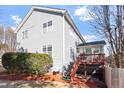 Back exterior featuring a two-story home and deck with painted stairs at 1218 Twelve Oaks Ln, Apex, NC 27502