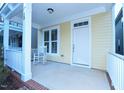 Inviting front porch with a white rocking chair and beautiful trim at 13 Danbury Ct, Pittsboro, NC 27312