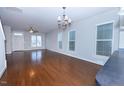 Bright and airy living room featuring hardwood floors and modern light fixtures at 13 Danbury Ct, Pittsboro, NC 27312