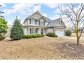 Charming two-story home featuring a manicured lawn and mature landscaping at 1426 Phelps Ridge Dr, Fuquay Varina, NC 27526