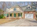 Charming home featuring brick accents, dormer windows, and a welcoming front porch at 1514 Wiljohn Rd, Garner, NC 27529