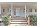 Welcoming front entrance featuring a well-lit porch with a classic door and manicured landscaping at 206 Spring Ln, Chapel Hill, NC 27514
