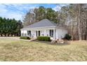 Inviting single-story home with a columned porch, well-maintained landscaping, and a serene setting at 208 Hunting Lodge Rd, Clayton, NC 27520