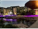 Night view of complex featuring modern architecture and a pond with purple lighting at 228 Adams St, Cary, NC 27513