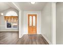 Bright entryway with a wooden front door, elegant flooring and a glimpse into the living area at 2318 Rogers Rd, Graham, NC 27253