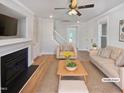 Bright living room showcasing a fireplace, neutral tones, and hardwood floors at 25 Scotch Bonnet Rdg, Clayton, NC 27520