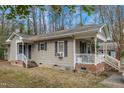 Inviting home exterior featuring a porch, siding, and well-maintained yard space at 2513 Drexall Ave, Durham, NC 27704