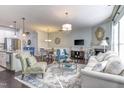 Bright living room boasts hardwood floors, a fireplace, stylish furnishings, and abundant natural light at 304 Presenteer Trl, Apex, NC 27539