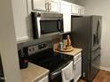 Stylish kitchen with stainless steel appliances, including a microwave and refrigerator at 312 East End Ave, Durham, NC 27703