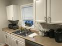 Bright kitchen featuring white cabinets, stainless steel sink, and modern appliances at 312 East End Ave, Durham, NC 27703