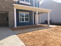 View of the blue sided home with a concrete sidewalk and covered porch at 319 N Maple Walk # 213, Garner, NC 27529