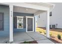 Inviting front porch with white columns and a gray front door, providing a charming entrance at 319 N Maple Walk # 213, Garner, NC 27529