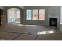 Spacious living room featuring a fireplace, and large windows creating a bright space at 319 N Maple Walk # 213, Garner, NC 27529