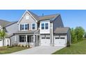 Charming home featuring gray siding, a two-car garage, and a well-maintained front lawn at 41 Silver Moon Ln # 115, Clayton, NC 27527