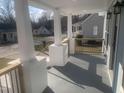 A charming porch with painted brick bases and light wood railing leads to the house entrance at 523 E Nelson Ave, Wake Forest, NC 27587
