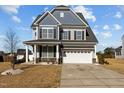 Attractive two-story home with a gray exterior, a two-car garage, and a well-maintained front lawn at 5601 Garnet Meadow Rd, Knightdale, NC 27545