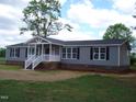 Well-maintained home with gray siding, crisp white trim, and a covered front entry at 5780 Plain View Hwy, Dunn, NC 28334