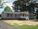 Gray-sided house with a white porch and black shutters at 5780 Plain View Hwy, Dunn, NC 28334