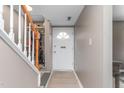 Inviting entryway features a staircase and a white front door with half-moon window detail at 627 W Front St # C, Burlington, NC 27215