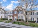 Attractive townhouses with manicured lawns and tree, showcasing neat landscaping at 706 Canyon Lake Cir, Morrisville, NC 27560