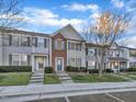 Well-maintained townhouse exteriors with tidy lawns and paved pathways leading to each home at 706 Canyon Lake Cir, Morrisville, NC 27560
