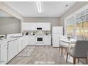 Bright kitchen with white appliances, ample counter space, and a cozy dining area at 706 Canyon Lake Cir, Morrisville, NC 27560