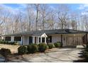 Charming single-story home with a covered carport and blue front door at 7414 Virgilina Rd, Roxboro, NC 27574
