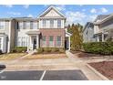 Inviting townhouse featuring neutral siding, meticulous landscaping, and a welcoming entryway at 7850 Silverthread Ln, Raleigh, NC 27617
