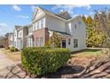 Attractive townhouse showcasing manicured bushes, classic siding, and a well-kept lawn at 7850 Silverthread Ln, Raleigh, NC 27617