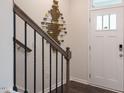 Welcoming entryway with modern light fixture and white front door with glass inset at 813 Washington St, Fuquay Varina, NC 27526