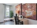 Cozy home office with a sleek desk, artwork, and natural light from a large window at 813 Washington St, Fuquay Varina, NC 27526
