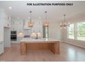 Spacious kitchen with a large center island, stainless steel appliances and wood floors at 825 Willow Tower Ct, Rolesville, NC 27571