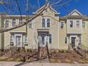 Beautiful townhouse featuring a landscaped front yard and classic architectural details at 916 Highgrove Dr, Chapel Hill, NC 27516
