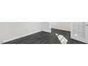 The room features dark wood-look floors and bright white doors and trim at 94 Paper Birch Way, Fuquay Varina, NC 27526