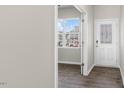 Welcoming entryway featuring wood-look floors, white door, sidelight and a view of the outdoors at 99 Paper Birch Way, Fuquay Varina, NC 27526