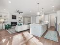 Open-concept living area with fireplace, comfortable seating, and adjacent kitchen at 104 Pointe Park Cir, Holly Springs, NC 27540