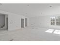 Bright, spacious living room featuring high ceilings and large windows offering ample natural light at 104 Pointe Park Cir, Holly Springs, NC 27540